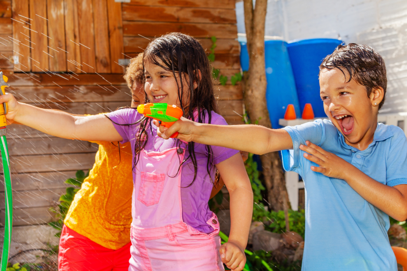 Kids playing water guns for sensory processing activity