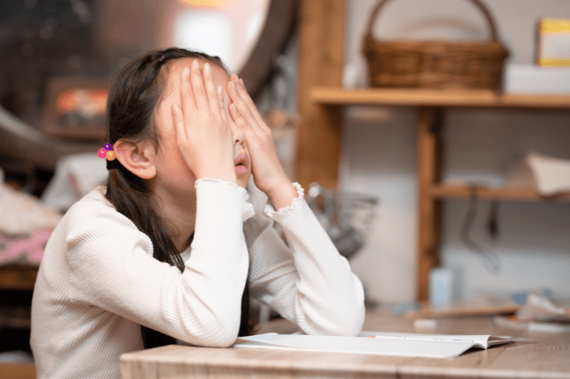 Speech therapist helping a child with dyslexia improve reading skills