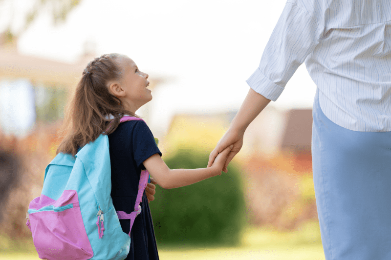 Mother taking daughter to school