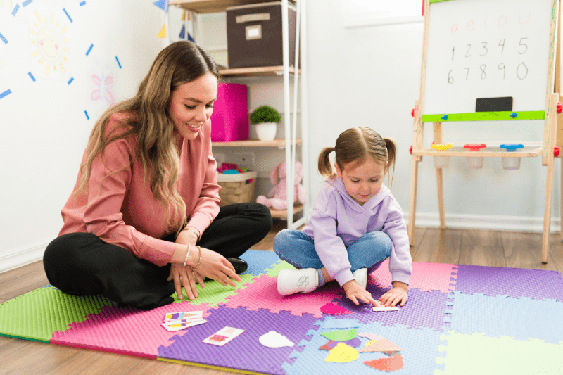 Child engaging in structured play with a speech pathologist as part of autism therapy in Sydney's northern beaches