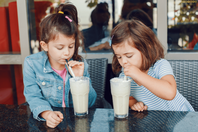 Kids drinking smoothies using a straw for sensory processing activity