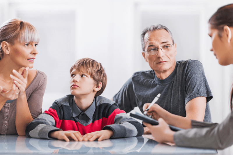 Parent discussing their child's management plan for autism treatment with a healthcare professional in Northern Beaches, Sydney.