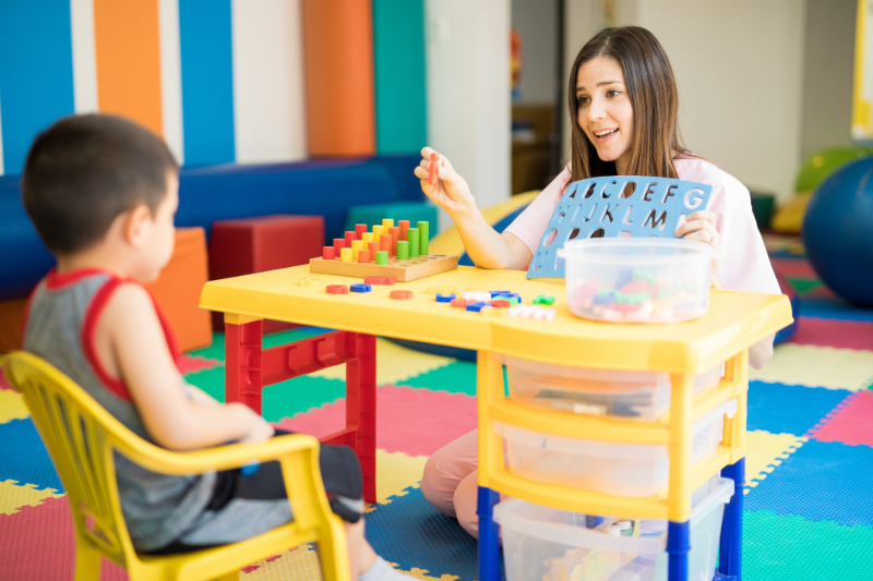 Speech therapist working on spelling with a child with dyslexia