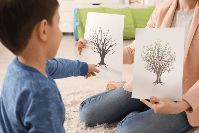 Early intervention specialist helping a young child with speech difficulties use communication tools.