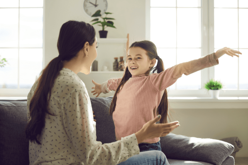 Smiling child confidently communicating with others.