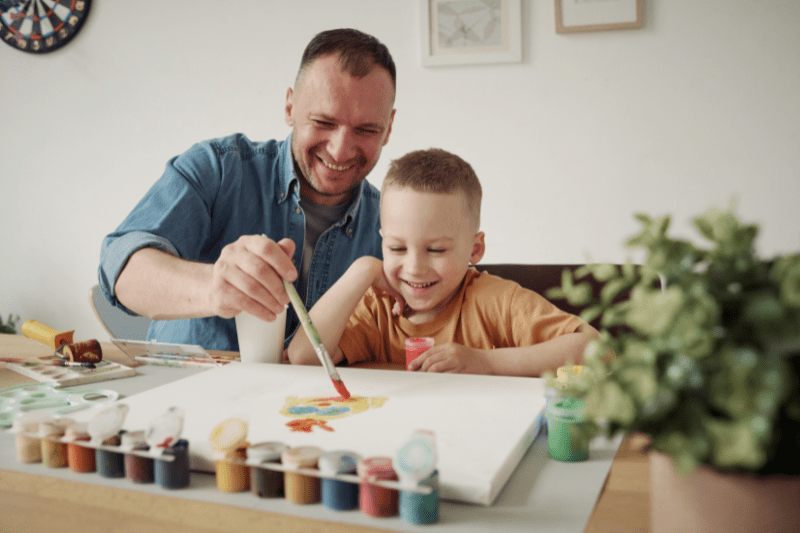 Child leading an art project during creative play with art supplies at Kids First Children’s Services.