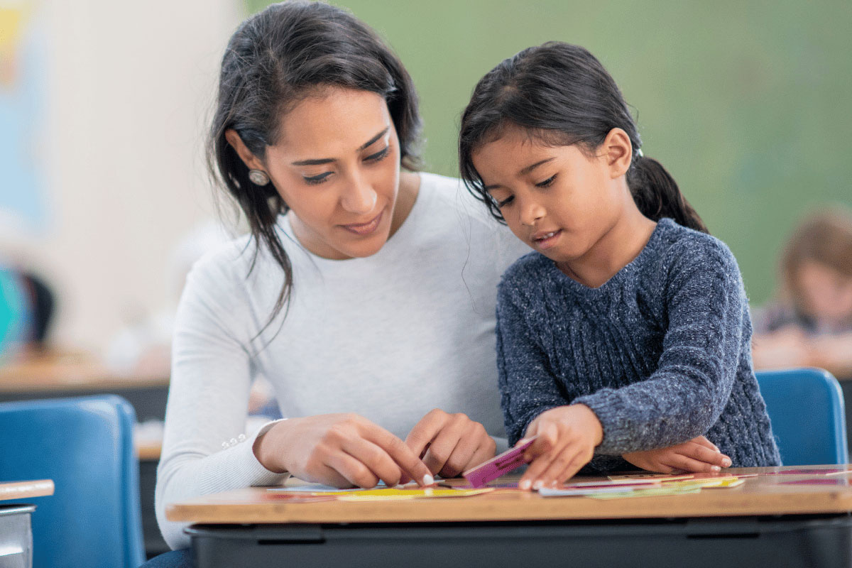 Speech pathologist at Kids First Children's Services supporting a child with reading and spelling using the Sounds-Write Literacy Program in Sydney's northern beaches.