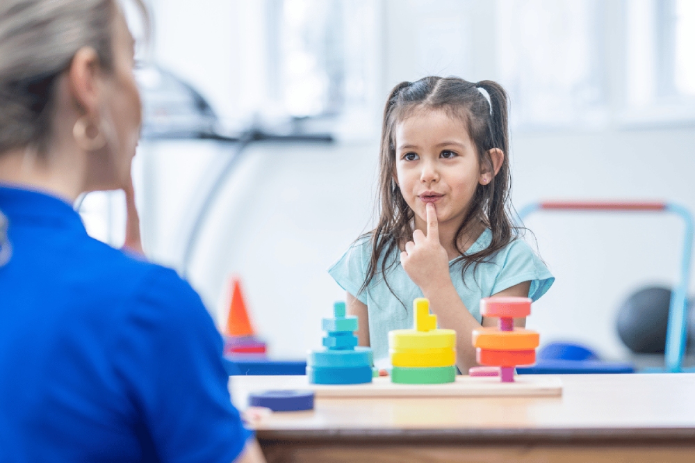 Child receiving play-based speech therapy for developmental delays at Kids First Children’s Services, highlighting tailored NDIS supports. Language Development Issues