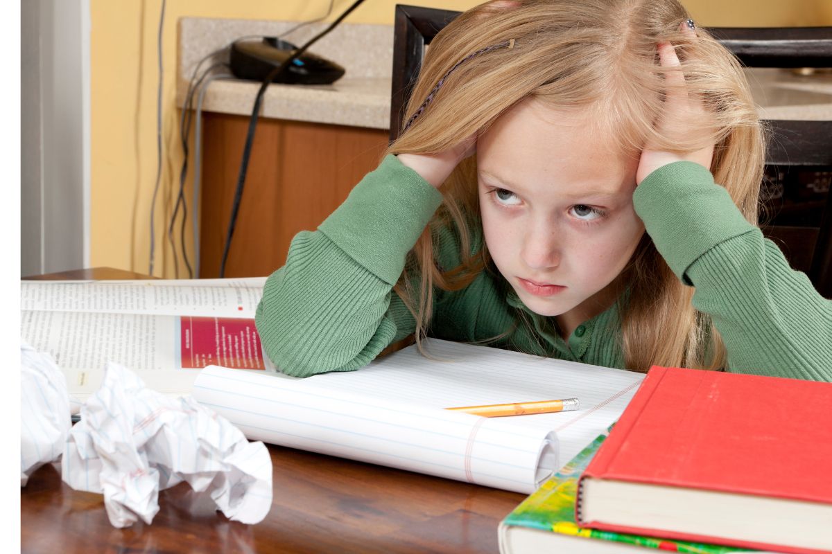 Young child struggling with reading during a school literacy task in the Northern Beaches