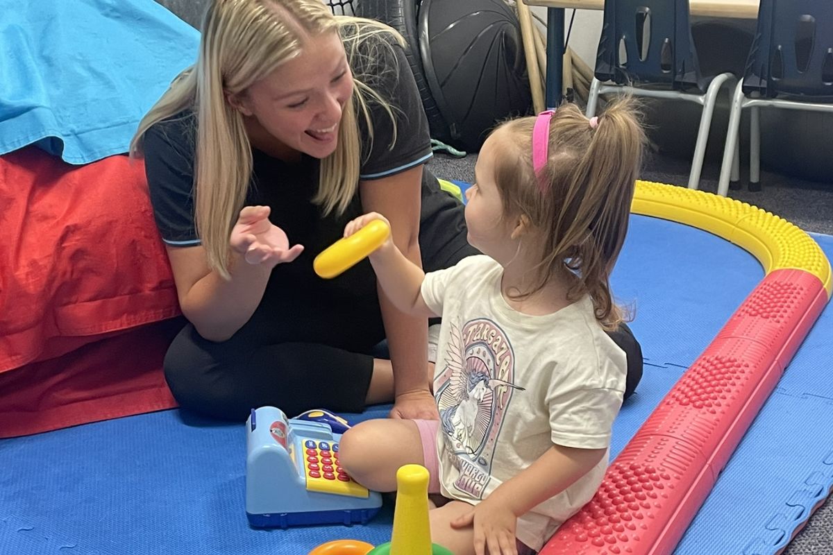 Speech pathologist working with a child in a multidisciplinary team at Kids First Children’s Services in Brookvale