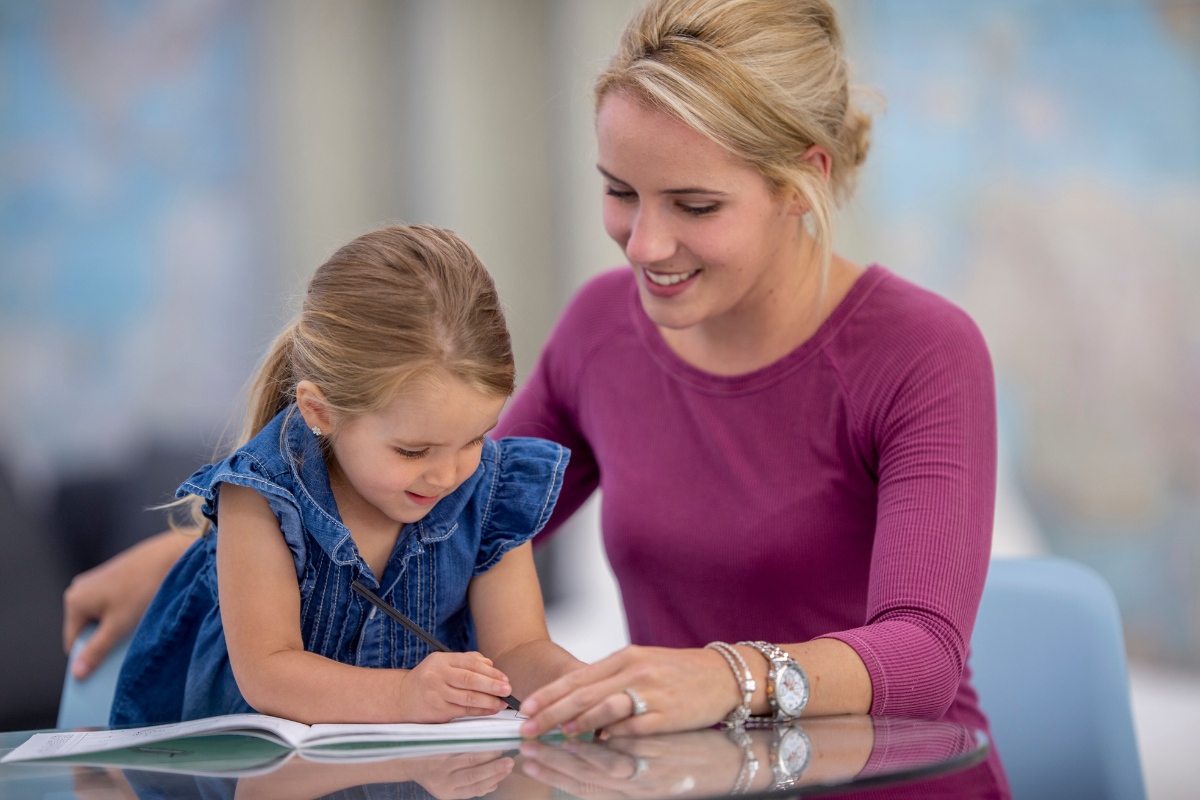 Primary school-aged child practising reading and spelling during a Sounds-Write literacy session at Kids First Children’s Services in Brookvale