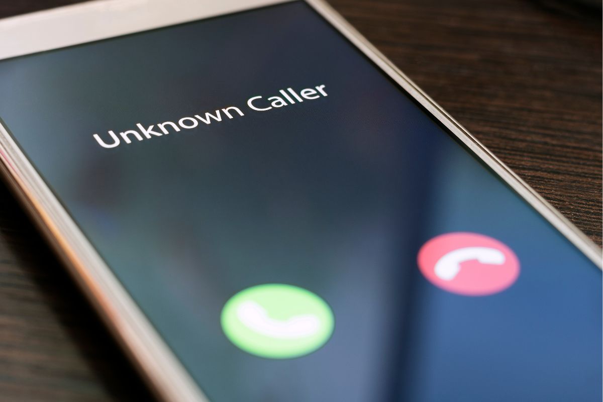 Phone showing a No Caller ID incoming call, reflecting how NDIS check-in calls can arrive unexpectedly for families