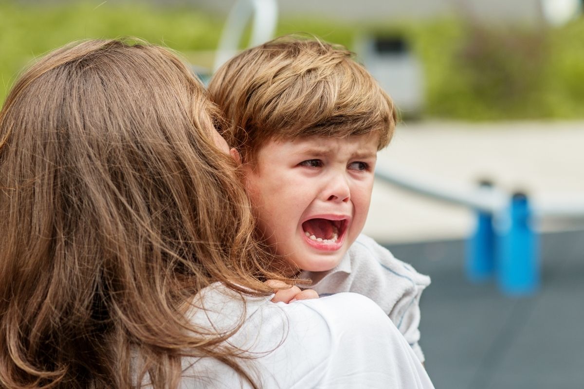 Child showing frustration and tantrum behaviour outdoors representing emotional overload after school explained by Kids First Children’s Services Northern Beaches