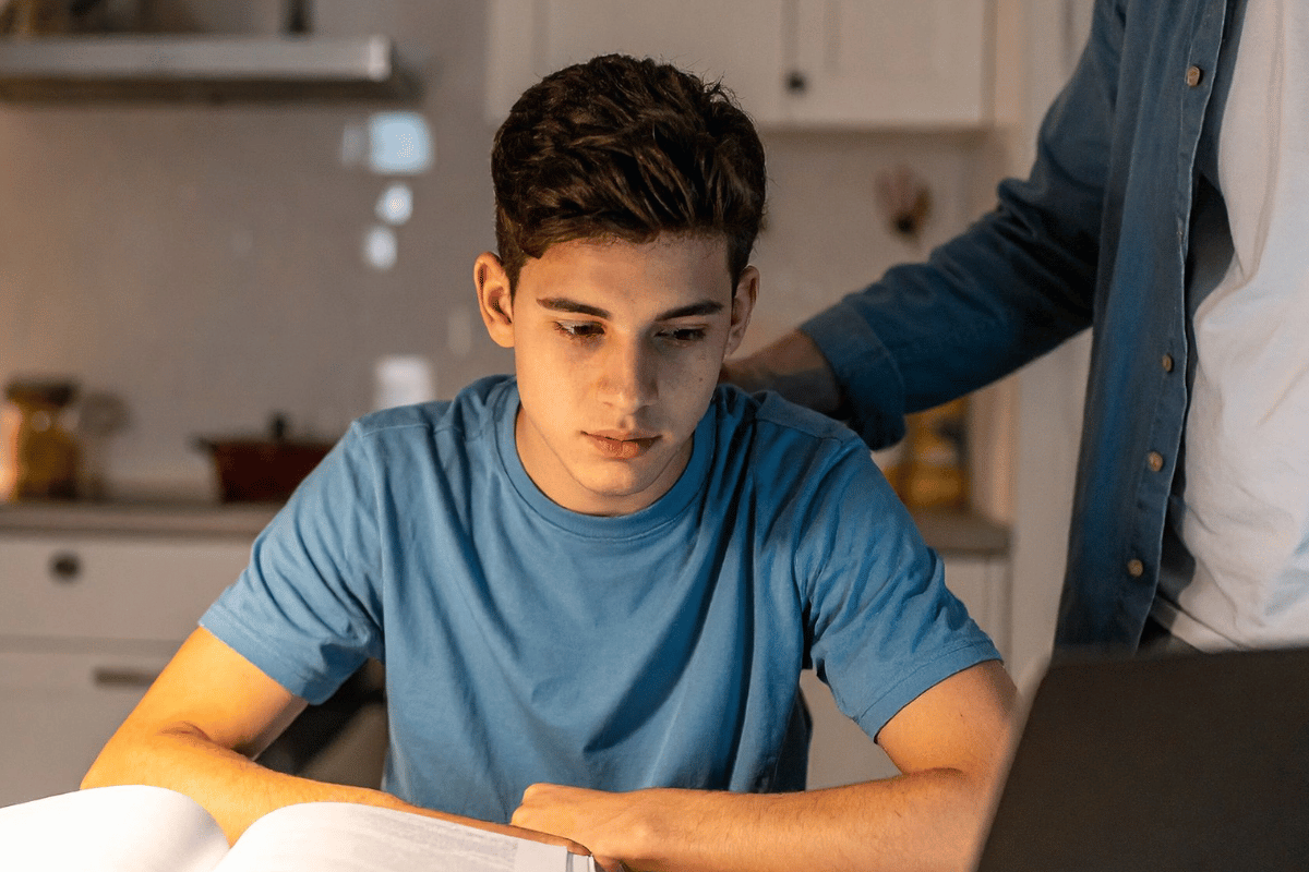 Older child with parent support during homework, representing dyslexia, reading difficulties and literacy concerns in Australian children