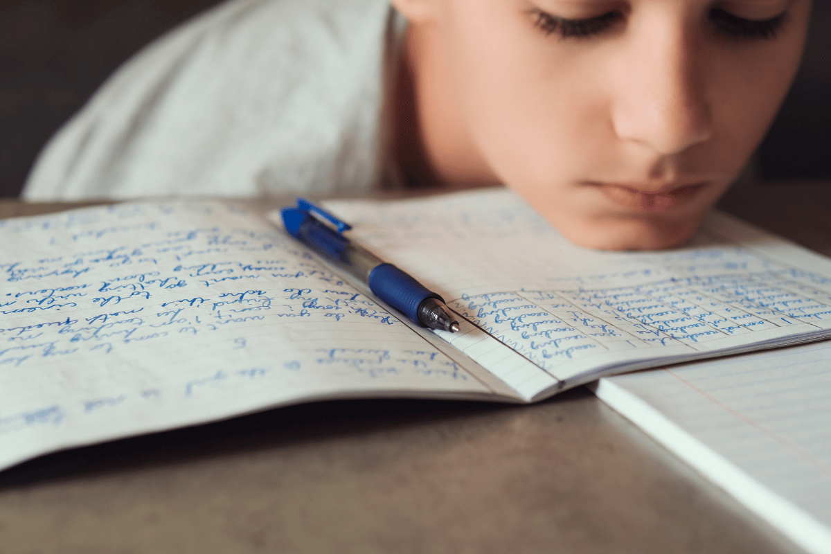 Child showing possible signs of dyslexia while working on writing and spelling tasks at home, supporting a Kids First Children’s Services article for Northern Beaches families